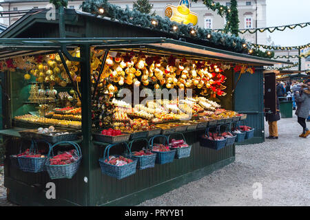 Salzburg, Austria - December 25, 2016: Christmas market with kiosks and stalls, people bying gifts Stock Photo