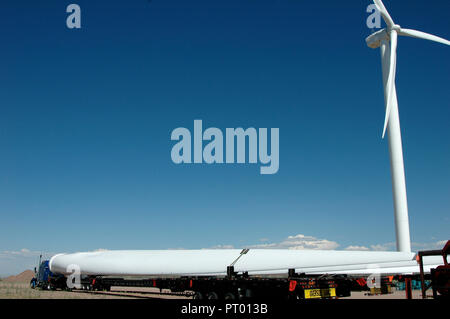 A wind turbine blade on a semi tractor trailer showing how large the turbine blades actually are. Stock Photo