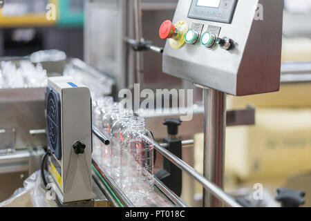 Clear water Bottles transfer on Conveyor Belt System. Industrial and factory with machine technology concept.