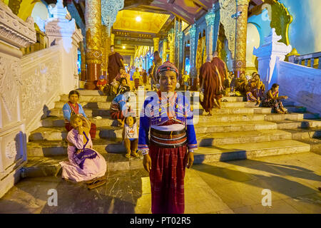 YANGON, MYANMAR - FEBRUARY 27, 2018: The portrait of a woman of Silver Palaung tribe (Kengtung), dressed in traditional attire with many silver jewelr Stock Photo