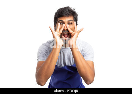 Mad supermarket or hypermarket indian male employee screaming with both hands around mouth isolated on white background Stock Photo