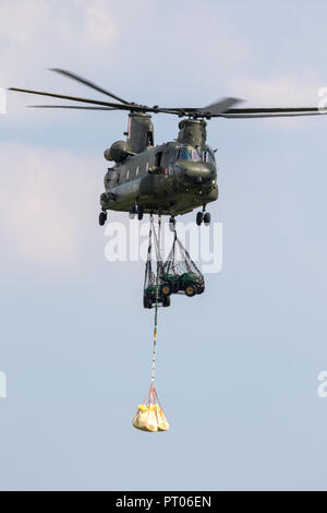 BERLIN - APR 27, 2018: British Royal Air Force Boeing CH-47 Chinook transport helicopter slingload demonstration at the Berlin ILA Air Show. Stock Photo
