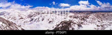 Perisher valley village between snow covered mountain ranges in Snowy mountains - popular australian winter sports resort for skiing and snowboarding. Stock Photo