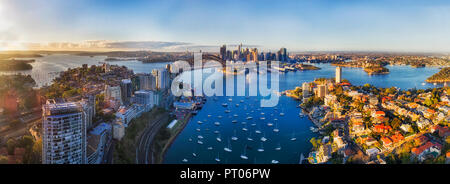 Soft sunlight in the morning over Sydney city CBD landmarks around Harbour and Lavender bay from Lower North SHore along Sydney Harbour bridge and The Stock Photo