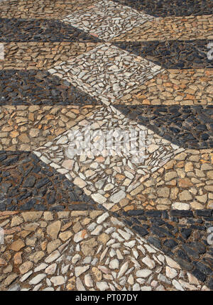 Typical black and white, Portuguese 'calcada' mosaic cobblestone paving. Elvas, Alentejo region, Portugal. Also found in Brazil and other countries wh Stock Photo
