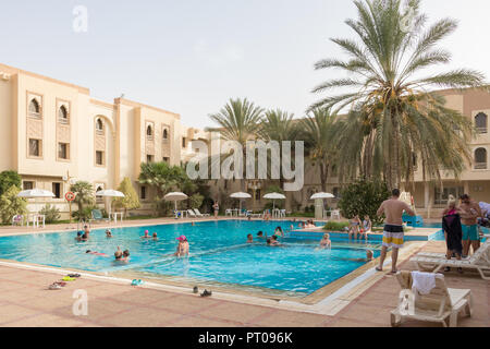 Swimming pool with tourists near Sahara desert, Douz, Tunisia, Africa Stock Photo