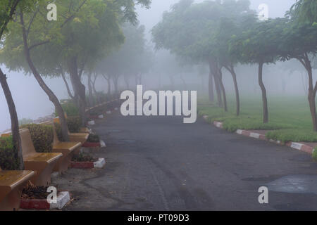 A misty, foggy morning in Ras al Khaimah, United Arab Emirates brings a wet and peaceful morning along the Corniche. Stock Photo