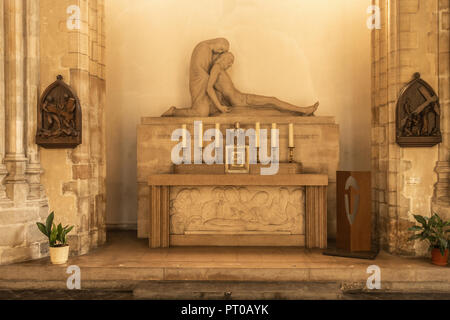 Dunkerque, France - September 16, 2018: Inside Saint Eloi Church in Dunkirk. Altar and statue of dead jesus against wall with stations of the cross ne Stock Photo