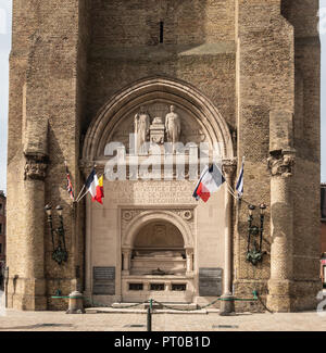 Dunkerque, France - September 16, 2018: Closeup of World wars memorial with flags at base of Belfry of Dunkirk. Fifty shades of brown broken by colors Stock Photo
