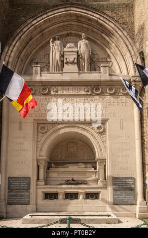 Dunkerque, France - September 16, 2018: Closeup of World wars memorial with flags at base of Belfry of Dunkirk. Fifty shades of brown broken by colors Stock Photo