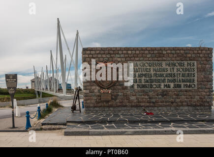Dunkerque, France - September 16, 2018: Brown stone war memorial commemorating the Battle for Dunkirk in world war 2 near the beach. Pedestrial suspen Stock Photo