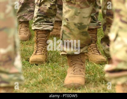 US soldiers legs in green camouflage military uniform. US troops Stock Photo