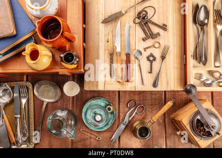 An overhead photo of many vintage objects, flea market stuff on a wooden background Stock Photo