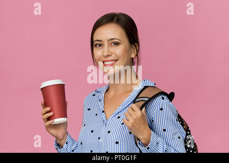 Beautiful and charming female student with backpack and cup of coffee Stock Photo