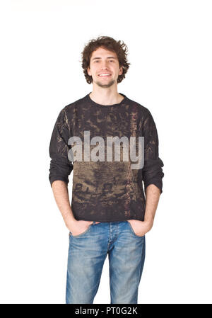 Young smiling man pointing his hands in pockets Stock Photo