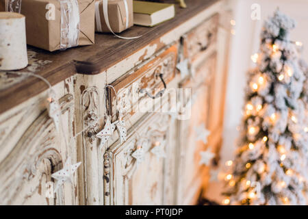 Christmas star and other decoration on ancient commode. Happy new year conception Stock Photo