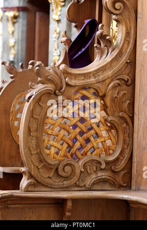 Wooden confessional with stole in the church and empty space for text Stock Photo