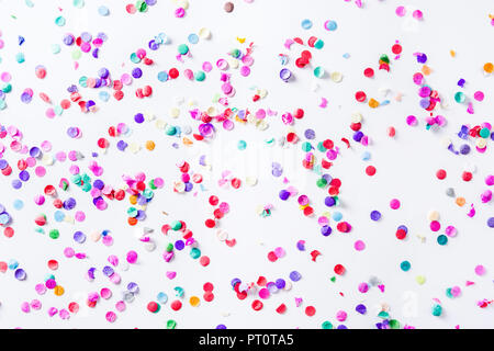 Party background. Party colorful confetti on white background. Top view. Stock Photo