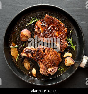 Grilled pork steak in frying pan, close up view. Top view, flat lay Stock Photo