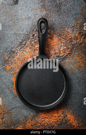 Empty black cast iron pan on an old protvine, top view Stock Photo