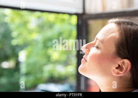 Close-up Of A Beautiful Woman Closing Her Eyes Stock Photo