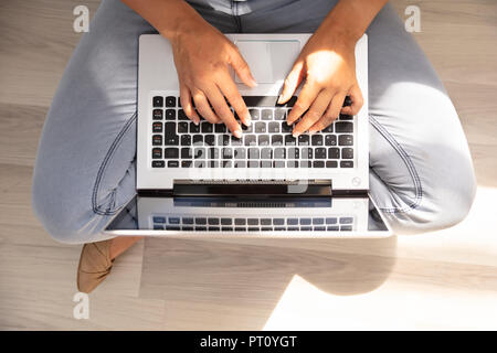 High Angle View Of A Woman's Hand Typing On Laptop Keypad Stock Photo