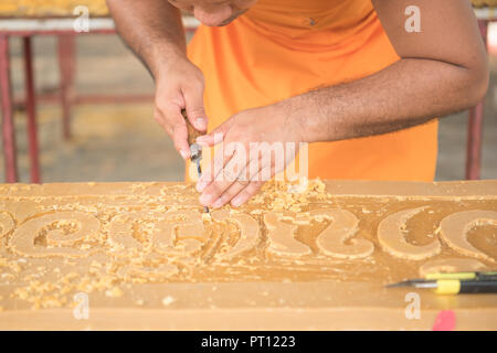 monk carving candle for candle festival in thailand Stock Photo