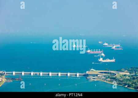 Singapore  - August 18 2018: Aerial view of Singapore sea scape with ships in blue sea featuring Marina Barrage Stock Photo