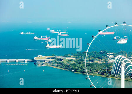 Singapore  - August 18 2018: Aerial view of Singapore sea scape with ships in blue sea featuring Marina Barrage Stock Photo