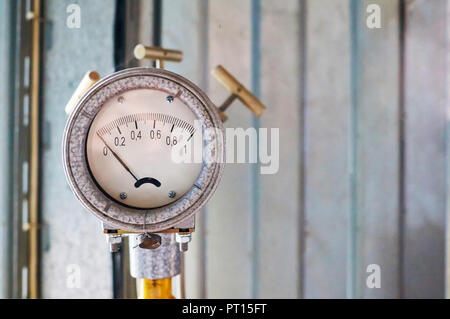 Manometer showing zero mounted on gas pipe colored yellow. Stock Photo