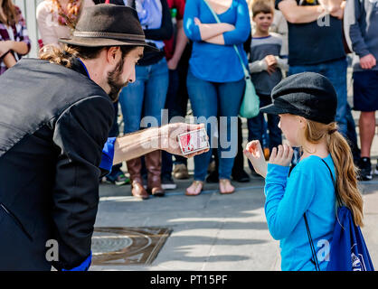 A magician performs magic tricks for tourists in Jackson Square, Nov. 11, 2015, in New Orleans, Louisiana. (Photo by Carmen K. Sisson/Cloudybright) Stock Photo