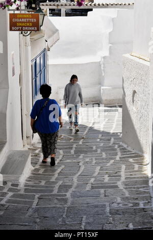 Greece, the island Ios, two people pass by in the old village Stock Photo