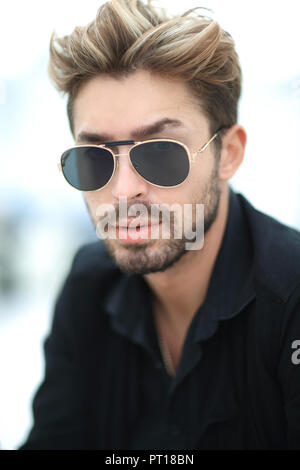 young handsome attractive bearded model man using smartphone in urban context Stock Photo