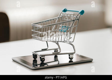 Empty mini shopping cart on tablet Stock Photo
