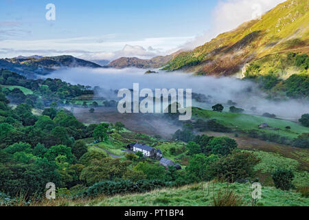 Early morning mist in the Gwynant Valley looking south west over Llynn (Lake) Gwynant Snowdonia National Park North Wales UK September Stock Photo