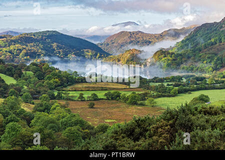 Early morning mist clearing over Llyn (Lake) Gwynant in the Gwynant Valley looking south west with the summit of Moel Hebog in background Snowdonia Stock Photo
