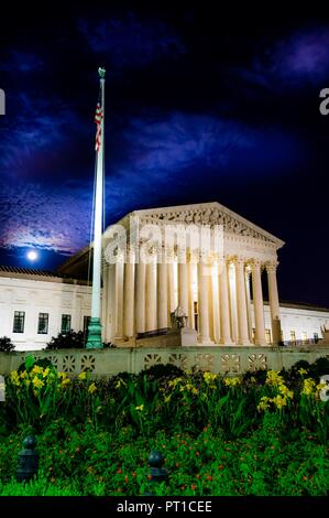 Time exposure of United States Supreme Court building in Washington DC at night with full moon and clouds in background during summer Stock Photo