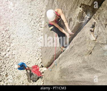 Austria, Innsbruck, Martinswand, woman climbing in rock wall Stock Photo