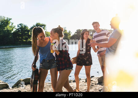 Group of happy friends walking at the riverside Stock Photo