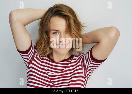 Portrait of smiling woman wearing red-white striped t-shirt Stock Photo