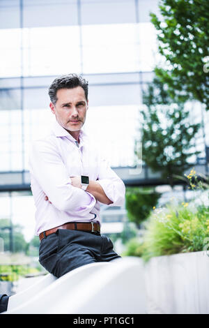 Portrait of confident businessman outside office building Stock Photo