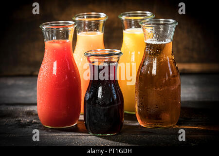 Glass bottles of various fruit juices Stock Photo