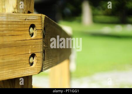 Selective focus shot of a woodpost in a park in the afternoon, shot in landscape