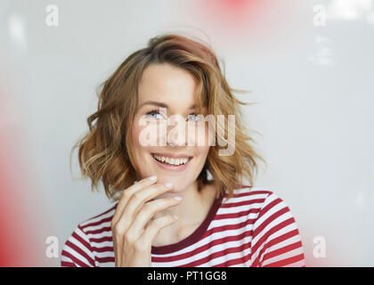 Portrait of smiling woman wearing red-white striped t-shirt Stock Photo