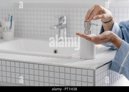 Close-up of woman wputting soap on her hands in bathroom Stock Photo