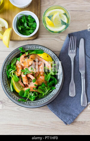 Shrimps with lamb's lettuce in bowl Stock Photo