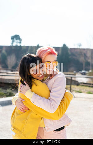 Portrait of two alternative friends embracing Stock Photo
