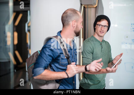Colleagues in office discussing work issues Stock Photo
