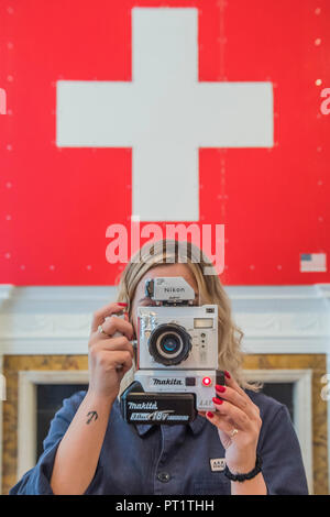 London, UK. 5th Oct 2018. 24h live performance  of Swiss Passport Office by American artist Tom Sachs at Galerie Thaddaeus Ropac London . Visitors can be issued with a Tom Sachs Studio Swiss passport from Friday 5 October, 6pm - Saturday 6 October, 6pm. Credit: Guy Bell/Alamy Live News Stock Photo