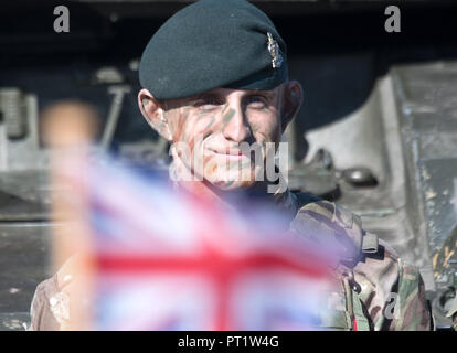 Augustdorf, Germany. 5th Oct 2018. A British soldier wearing camouflage paint standing in front of a tank during a signing ceremony. Defence Minister von der Leyen and her British counterpart signed a 'Joint Vision Statement', a bilateral declaration on closer cooperation in security and defence matters. Photo: Ralf Hirschberger/dpa Credit: dpa picture alliance/Alamy Live News Stock Photo